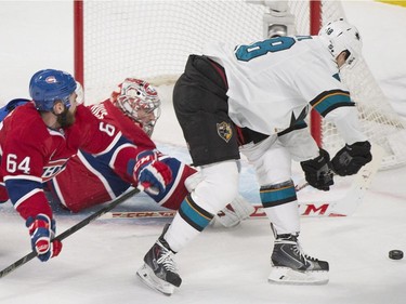 San Jose Sharks' Tomas Hertl, right, moves in on Montreal Canadiens goaltender Carey Price, centre, as Canadiens' Greh Pateryn defends during first period NHL hockey action in Montreal, Saturday, March 21, 2015.
