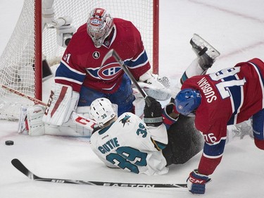 Montreal Canadiens goaltender Carey Price makes a save on San Jose Sharks' Logan Couture, centre, as Canadiens' P.K. Subban defends during second period NHL hockey action in Montreal, Saturday, March 21, 2015.
