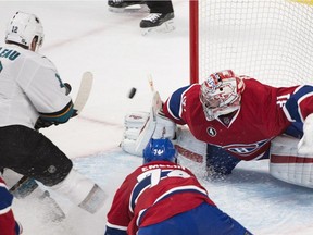 Montreal Canadiens goaltender Carey Price makes a save on San Jose Sharks' Patrick Marleau (12) as Alexei Emelin (74) defends during third period NHL hockey action in Montreal, Saturday, March 21, 2015.