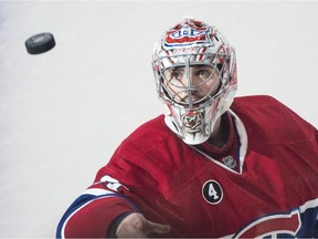Canadiens goaltender Carey Price tosses a puck to fans after being named the game's first star following a 2-0 win over the San Jose Sharks at the Bell Centre on March 21, 2015.