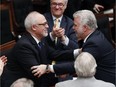 Quebec Finance Minister Carlos Leitao is congratulated by Quebec Premier Philippe Couillard after he presented a provincial budget, Thursday, March 26, 2015 at the legislature in Quebec City.