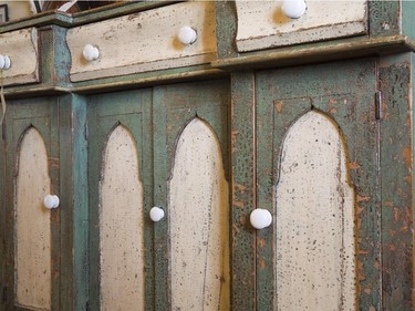 Close-up of the fine woodworking details on a buffet crafted in the 1800s.