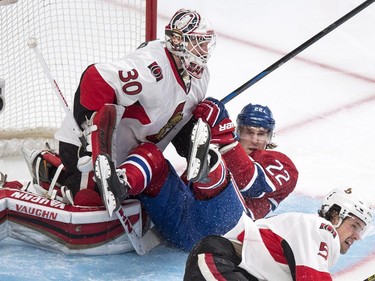 Dale Weise slides into Ottawa Senators goalie Andrew Hammond during first-period action at the Bell Centre on Thursday, March 12, 2015 in Montreal.