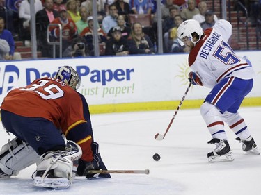 Montreal Canadiens centre David Desharnais attempts a shot on the goal that was deflected by Florida Panthers goalie Dan Ellis during the first period Tuesday, March 17, 2015,  in Sunrise, Fla.