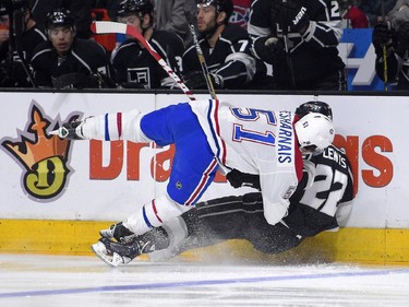 Montreal Canadiens centre David Desharnais, left, collides with Los Angeles Kings centre Trevor Lewis during the first period of an NHL hockey game, Thursday, March 5, 2015, in Los Angeles.