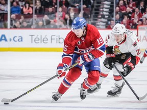 P.A. Parenteau skates past the Ottawa Senators' Matt Puempel during game at the Bell Centre in Montreal on March 12, 2015.