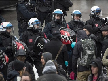 Demonstrators are surrounded by riot police during the annual anti-police brutality demo, Sunday, March 15, 2015, in Montreal.