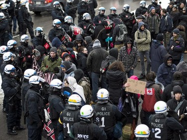 Demonstrators are surrounded by riot police during the annual anti-police brutality demo, Sunday, March 15, 2015, in Montreal.