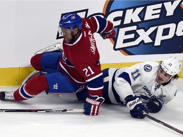 Montreal Canadiens right wing Devante Smith-Pelly and Tampa Bay Lightning left wing Ondrej Palat fall to the ice in first- period action at the Bell Centre on Tuesday, March 10, 2015.