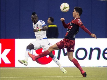 LD Alajuelense's Ariel Soto kicks the ball away from Montreal Impact's Dominic Oduro during first half CONCACAF soccer semi-final action Wednesday, March 18, 2015, in Montreal.