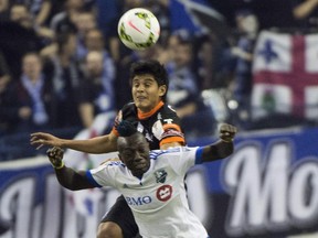 The Impact's Dominic Oduro (front) and Pachuca's Miguel Herrera battle for position during CONCACAF Champions League game at Montreal's Olympic Stadium on March 3, 2015.