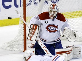 Montreal Canadiens goalie Dustin Tokarski watches the puck go past the net during the third period of an NHL hockey game against the Florida Panthers, Tuesday, March 17, 2015,  in Sunrise, Fla. The Canadiens defeated the Panthers 3-2.