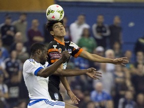 Pachuca's Erick Gutiérrez heads the ball away from the Impact's Nigel Reo-Coker during CONCACAF Champions League game at Montreal's Olympic Stadium on March 3, 2015.