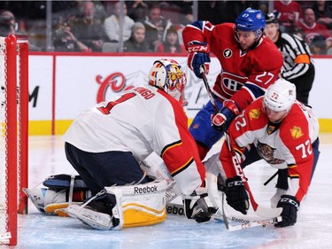 Roberto Luongo #1 of the Florida Panthers stops the puck on an attempt by Alex Galchenyuk #27 of the Montreal Canadiens during the NHL game at the Bell Centre on March 28, 2015, in Montreal.