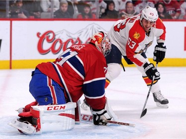 Carey Price #31 of the Montreal Canadiens stops the puck on an attempt by Dave Bolland #63 of the Florida Panthers during the NHL game at the Bell Centre on March 28, 2015, in Montreal.