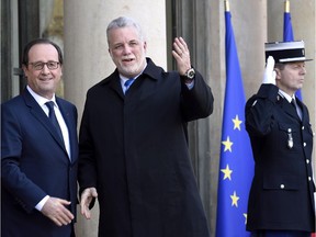 French President François Hollande, left, welcomes Quebec's Premier Philippe Couillard prior a working meeting in Paris on March 2, 2015.