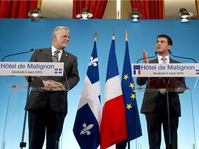 French Prime Minister Manuel Valls  (R) gives a press conference with Quebec's Prime minister Philippe Couillard (L) after a meeting at the Matignon hotel in Paris, on March 6, 2015.