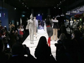 Manequins adorned with creations by French fashion designer Jean Paul Gaultier are displayed to recreate a catwalk during a press-preview of an exhibition devoted to Gaultier's work on March 30, 2015 in Paris.  An exhibition showcasing the work of Jean Paul Gaultier is set to open at the Grand Palais in Paris from April 1, to August 3, 2015.