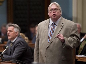 Quebec Health Minister Gaetan Barrette responds to the Opposition, to deny a rumour on the limitations of access to abortions, Wednesday, March 25, 2015 at the legislature in Quebec City.