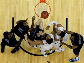 Rico Gathers (middle in white jersey) of the Baylor Bears goes up against T.J. Shipes of the Georgia State Panthers during NCAA March Madness game on March 19 in Jacksonville, Fla. Georgia State, seeded 14th, upset No. 3 seed Baylor 57-56.