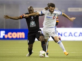 The Impact's Ignacio Piatti battles for the ball against Pachuca's Aquivaldo Mosquera during CONCACAF Champions League soccer action at Montreal's Olympic Stadium on March 3, 2015.