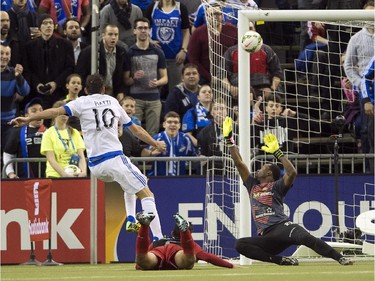 Montreal Impact's Ignacio Piatti scores the first goal against LD Alajuelense goalkeeper Lewis Dexter during first half CONCACAF semi-final soccer action Wednesday, March 18, 2015, in Montreal.