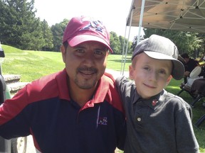 Former Montreal Alouettes’ quarterback Anthony Calvillo and eight-year-old pal Carter Brown at a golf tournament held to raise funds for the new Shriners Hospital for Children-Canada in August.