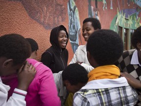 In this photo taken Monday, March 24, 2014, Rwandan students joke amongst themselves after finishing an examination and waiting to eat lunch at the Agahozo-Shalom Youth Village near Rwamagana, in Rwanda.