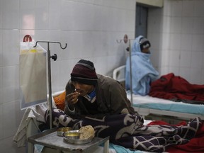 In this Sunday, Feb. 2, 2014 photo, an unidentified patient suffering from tuberculosis eats his meal on his bed at Lal Bahadur Shastri Government Hospital at Ram Nagar in Varanasi, India. India has the highest incidence of TB in the world, according to the World Health Organization's Global Tuberculosis Report 2013, with as many as 2.4 million cases. India saw the greatest increase in multidrug-resistant TB between 2011 and 2012. The disease kills about 300,000 people every year in the country.