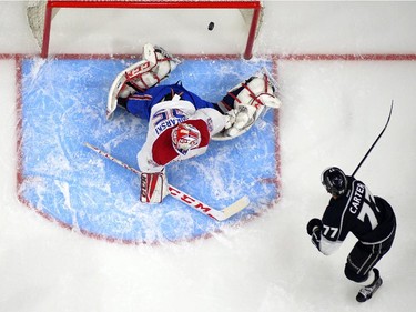 Los Angeles Kings centre Jeff Carter, right, scores on Montreal Canadiens goalie Dustin Tokarski during the first period of an NHL hockey game, Thursday, March 5, 2015, in Los Angeles.
