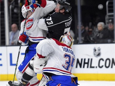 Montreal Canadiens defenceman Jeff Petry, upper left, and Los Angeles Kings centre Tyler Toffoli collide in front of Canadiens goalie Dustin Tokarski as the puck flies by during the second period of an NHL hockey game, Thursday, March 5, 2015, in Los Angeles.