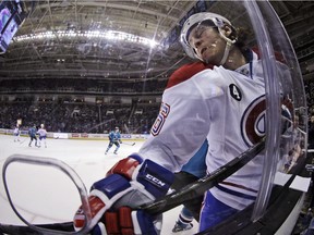 Montreal Canadiens' Jeff Petry is pressed against the boards by a San Jose Sharks player March 2, 2015, in San Jose, Calif.
