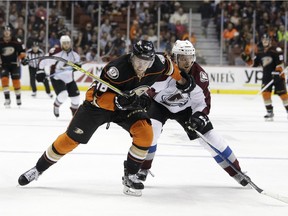 The Anaheim Ducks' Jiri Sekac, left,  and the Colorado Avalanche's Nate Guenin skate after loose puck during game on March 20, 2015, in Anaheim, Calif.