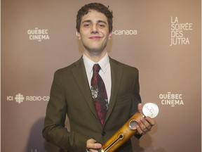 Xavier Dolan holds up his trophy for best director at the Jutra awards ceremony in Montreal, Sunday, March 15, 2015.