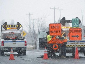 Workers set up a road block in the town of Varennes on Saturday, March 21, 2015, following a toxic gas leak at Kronos Canada Inc. factory. Fifteen homes and three factories have been evacuated on Saturday after titanium chloride was released into the atmosphere.