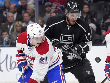 Montreal Canadiens centre Lars Eller, left, of Denmark, and Los Angeles Kings left wing Dwight King watch the puck during the second period of an NHL hockey game, Thursday, March 5, 2015, in Los Angeles.