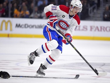 Montreal Canadiens centre Lars Eller, of Denmark, jumps over a stick during the first period of an NHL hockey game against the Los Angeles Kings, Thursday, March 5, 2015, in Los Angeles.
