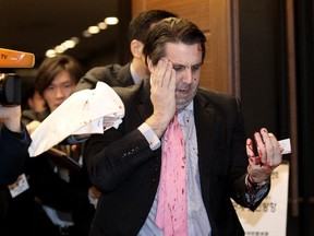 U.S. Ambassador to South Korea Mark Lippert leaves a lecture hall for a hospital in Seoul, South Korea, Thursday, March 5, 2015 after being attacked by a man. Lippert was attacked by a man wielding a razor and screaming that the rival Koreas should be unified, South Korean police and media said Thursday.