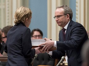 Quebec Treasury Board president Martin Coiteux, right, tables spending estimates Thursday, March 26, 2015 at the legislature in Quebec City.