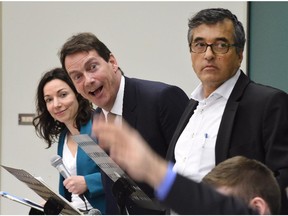 Parti Quebecois Leadership candidate Pierre-Karl Peladeau, centre, makes a face as the organisers explain the rules of a leadership debate on Wednesday, March 18, 2015 at Laval University in Quebec City. Peladeau is flanked by candidates Martine Ouellet, left, and Pierre Cere.