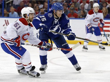 Tampa Bay Lightning's Matt Carle defends against Montreal Canadiens' David Desharnais during the second period Monday, March 16, 2015, in Tampa, Fla.