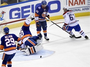 Montreal Canadiens left wing Max Pacioretty (67) celebrates after he shoots the puck past New York Islanders goalie Michal Neuvirth (30) as center Brock Nelson (29) and defenseman Johnny Boychuk (55) react in the second period of an NHL hockey game on Saturday, March 14, 2015, in Uniondale, N.Y. The Canadiens won 3-1.