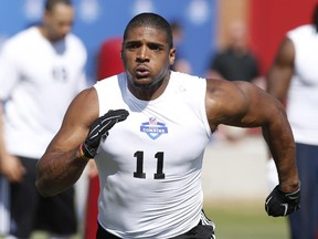 Defensive End Michael Sam, from Missouri, runs through a drill during the NFL Super Regional Combine football workout, Sunday, March 22, 2015, in Tempe, Ariz.