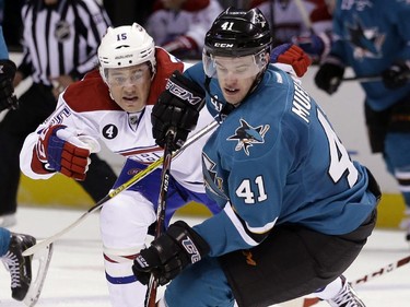 San Jose Sharks' Mirco Mueller (41) controls the puck next to Montreal Canadiens' Pierre-Alexandre Parenteau during the second period of an NHL hockey game Monday, March 2, 2015, in San Jose, Calif.