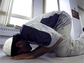 A Concordia University student prays in the university's Muslim prayer room in Montreal, Tuesday, May 13, 2003.