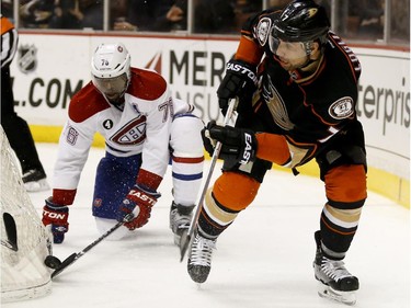 Montreal Canadiens defenceman P.K. Subban, left, and Anaheim Ducks centre Andrew Cogliano reach for the puck behind the net during the second period of an NHL hockey game in Anaheim, Calif., Wednesday, March 4, 2015.