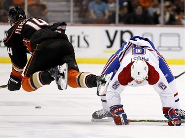Montreal Canadiens right wing Brandon Prust, right, and Anaheim Ducks left wing Tomas Fleischmann collide during the first period of an NHL hockey game in Anaheim, Calif., Wednesday, March 4, 2015.