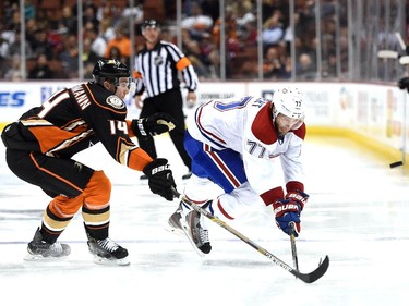 Tom Gilbert (77) of the Montreal Canadiens keeps the puck in ahead of Tomas Fleischmann (14) of the Anaheim Ducks during the second period at Honda Center on March 4, 2015 in Anaheim, California.