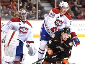 Canadiens defenceman Jeff Petry checks the Ducks' Tomas Fleischmann in front of goalie Carey Price during game in Anaheim on March 4, 2015. The Ducks won 3-1.
