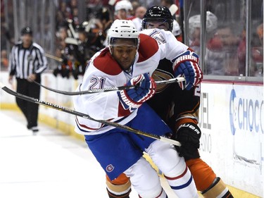 Devante Smith-Pelly (21) of the Montreal Canadiens chases after the puck as he is hooked by Kyle Palmieri (21) of the Anaheim Ducks during the first period at Honda Center on March 4, 2015 in Anaheim, California.
